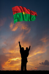 Father with son and the flag of Burkina Faso