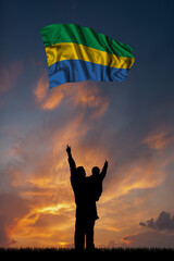Father with son and the flag of Gabon