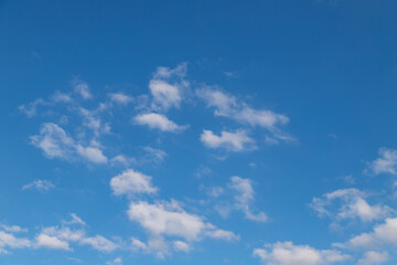 Blue sky with a few clouds background.