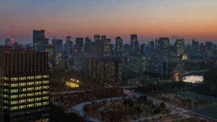 Sunset in Tokyo. View of the city center with modern skyscrapers and the iconic Mount Fuji