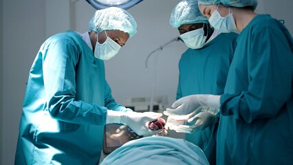 Team of surgeon doctors in operating room undergoing heart transplant surgery for patient to save...