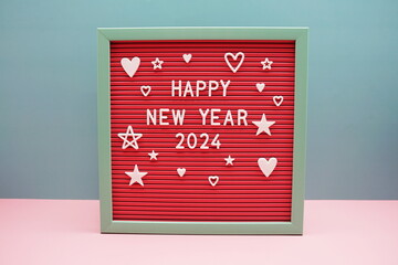 Happy New Year 2024 alphabet letters on pink and blue background