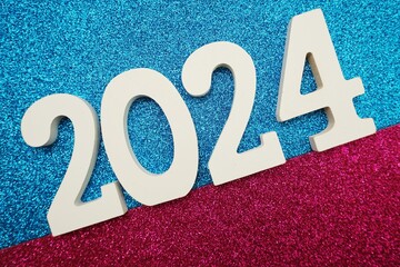 Happy New year 2024 with space copy on pink and blue glitter background
