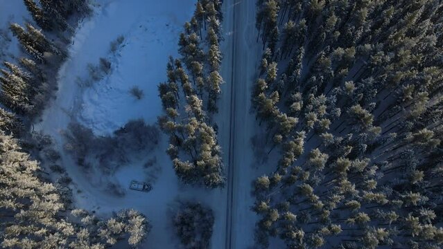 Frozen winter landscape and icy road from above