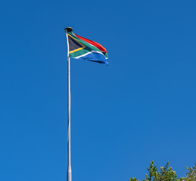 South Africa flag against blue sky in Cape Town South Africa