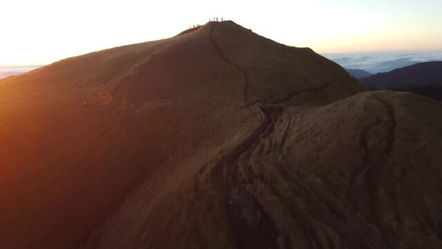 Aerial video of Mount Pulag at sunset with people in the background, the third highest mountain 