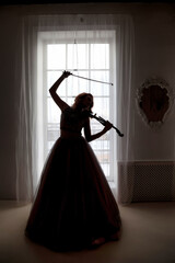Silhouette cover woman posing violin at large light window background, full length. Cute happy lady...