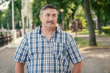 Portrait of a very old man 70 years old. Grandpa is resting in the summer outdoors. Portrait: aged,...