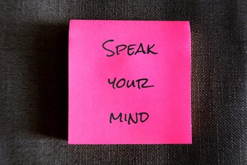 Pink note with text handwriting SPEAK YOUR MIND, self reminder to be true to yourself, express...
