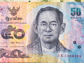 Macro detail with a 50 Thai Baht banknote. the baht is the official currency of Thailand