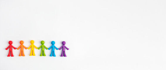 Multicoloured figurines of men on a light-coloured background . Concept of family, society, non-traditional relationships.
