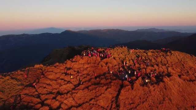 Aerial video of Mount Pulag at sunset with people in the background, the third highest mountain 