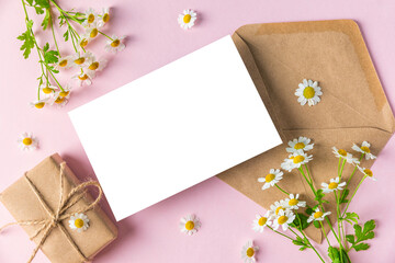Womens day, Mothers day greeting card with white chamomile flowers and gift box. Festive background. Mock up © samael334