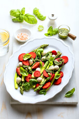 Green asparagus, strawberry, mozzarella cheese and pesto sauce salad