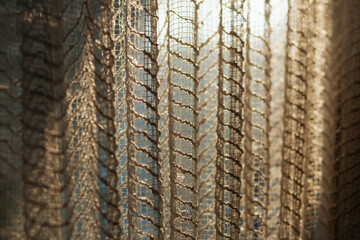 Textured see thru curtains on bedroom window with early morning light coming thru