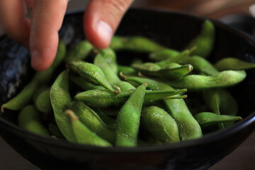 Man Eating Salted Edamame