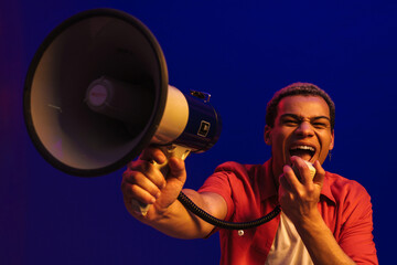 African man screaming in megaphone, making announcement isolated over neon blue background