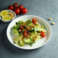 Healthy green salad with cherry tomatoes and peanut