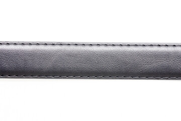 Naklejka premium Black leather belt. Isolated on white. Long strap. Sewed strap closeup cutout.