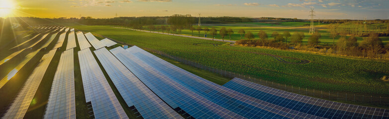 Photovoltaic panels on open spaces. The solar park along highway. View of a solar power station,...