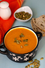 Healthy pumpkin soup with vegetables and pumpkin seeds - 575915833