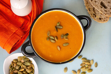 Healthy pumpkin soup with vegetables and pumpkin seeds - 575915870