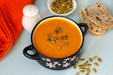 Healthy pumpkin soup with vegetables and pumpkin seeds - 575915883