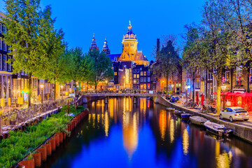 Amsterdam, Netherlands. Basilica of Saint Nicholas and canal houses of Amsterdam.