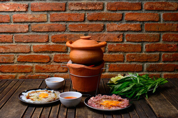 Hot pot thai style. Hot pot with clear soup in the clay cooking pot.