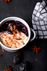 Typical Peruvian dessert: rice pudding and purple mazamorra on a dark background.