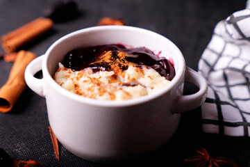 Typical Peruvian dessert: rice pudding and purple mazamorra on a dark background.