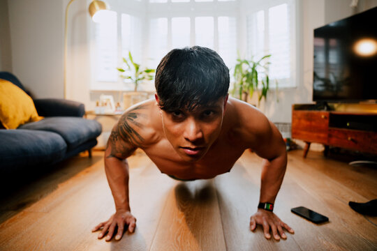 Young Asian working out at home