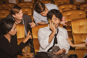 Concept Etiquette in the cinema Do not talk on the phone to disturb others : Selfish men talking on...
