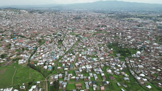 Aerial view of Mbeya city in Tanzania, Africa. Town located in south west of Tanzania. Narrow highland valley surrounded by a bowl of high mountains.