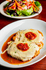 Chicken Parmesan or parmigiana. Italian comfort dish. Chicken breast covered in breadcrumbs fried,...