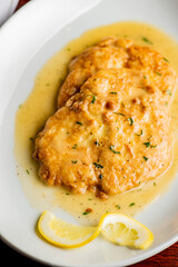 Italian Chicken Parmesan or parmigiana. Italian comfort dish. Chicken breast in breadcrumbs fried, topped with marinara sauce, melted mozzarella, parmigiana and provolone cheeses and Italian parsley. 