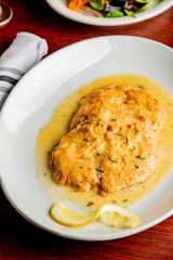Italian Chicken Parmesan or parmigiana. Italian comfort dish. Chicken breast in breadcrumbs fried, topped with marinara sauce, melted mozzarella, parmigiana and provolone cheeses and Italian parsley. 