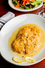 Italian Chicken Parmesan or parmigiana. Italian comfort dish. Chicken breast in breadcrumbs fried, topped with marinara sauce, melted mozzarella, parmigiana and provolone cheeses and Italian parsley. 