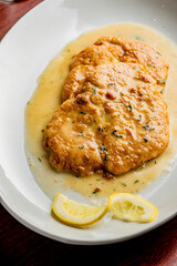 Italian Chicken Parmesan or parmigiana. Italian comfort dish. Chicken breast in breadcrumbs fried, topped with marinara sauce, melted mozzarella, parmigiana and provolone cheeses and Italian parsley. 