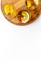 Alcoholic cocktails with oganges and ice in glasses. Alcoholic drinks background