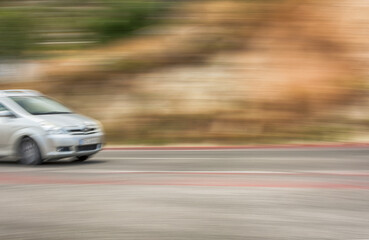 The car is driving at high speed on the autobahn. Motion blur. Copy-space.
