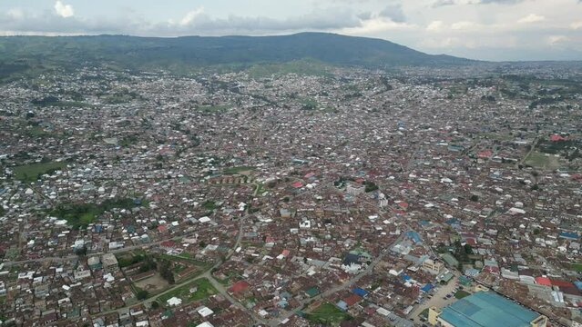 Aerial view of Mbeya city in Tanzania, Africa. Town is located in south west of Tanzania. Narrow highland valley surrounded by a bowl of high mountains.