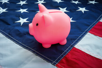 The US flag and a piggy bank on it as a symbol of savings and the USA government pension.