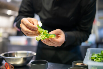 Obraz na płótnie Canvas Chef cooking vegetables salad on restaurant kitchen