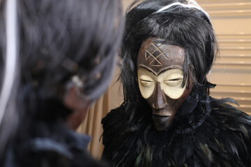 Spooky masked lady looking at her reflection