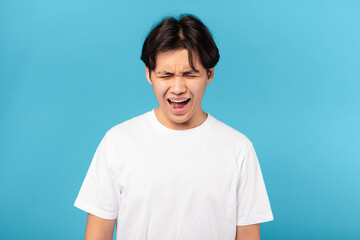 Sad Asian Teen Guy Shouting Loudly Crying Over Blue Background