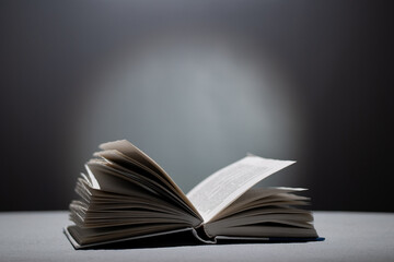 Opened book on a dark gray background