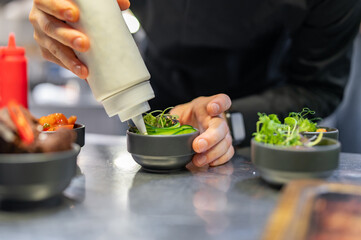 Chef cooking vegetables salad on restaurant kitchen