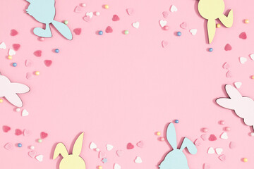 Easter holiday composition. Easter decorations, colorful sugar candy sprinkles isolated on pastel pink background. Easter concept. Flat lay, top view, copy space 