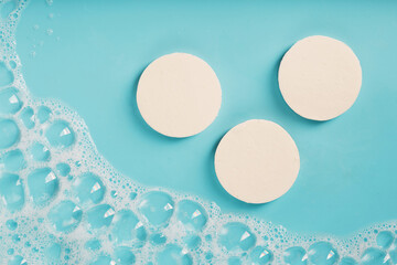 Three bars of round soap with foam